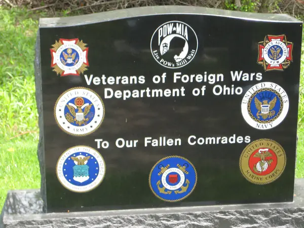 A polished black granite VFW Department of Ohio memorial with a POW-MIA emblem, six service seals in colour and a dedication to fallen comrades