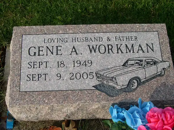 A rose granite bevel marker with a relationship line, a name and dates, and an etched classic car at one corner