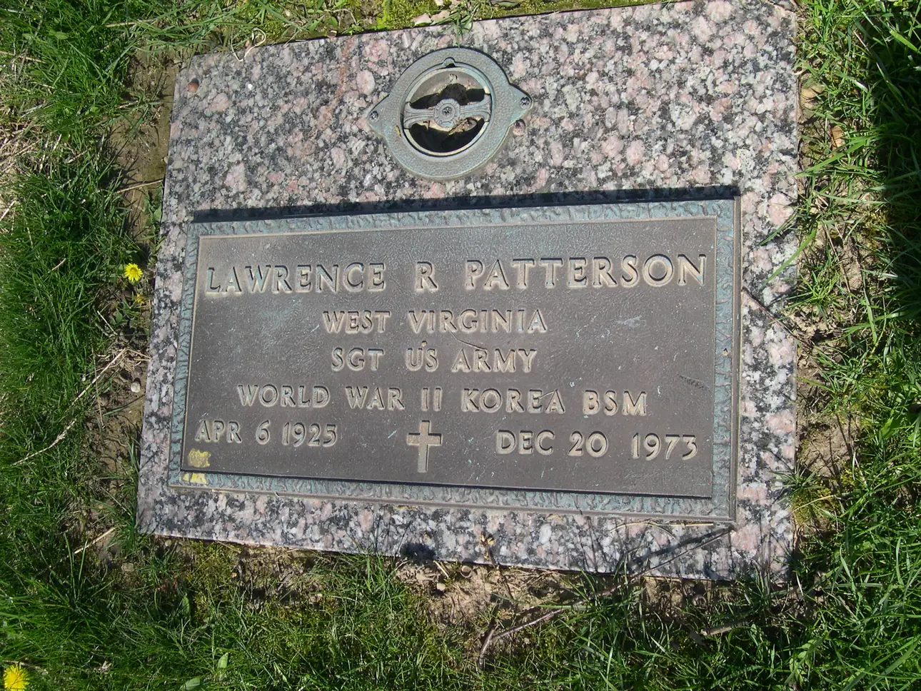 A bronze VA marker on a granite base, set flush in the grass, inscribed for a sergeant who served in World War II and Korea.