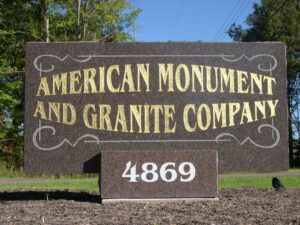 Stone sign for American Monument and Granite Company with address number 4869
